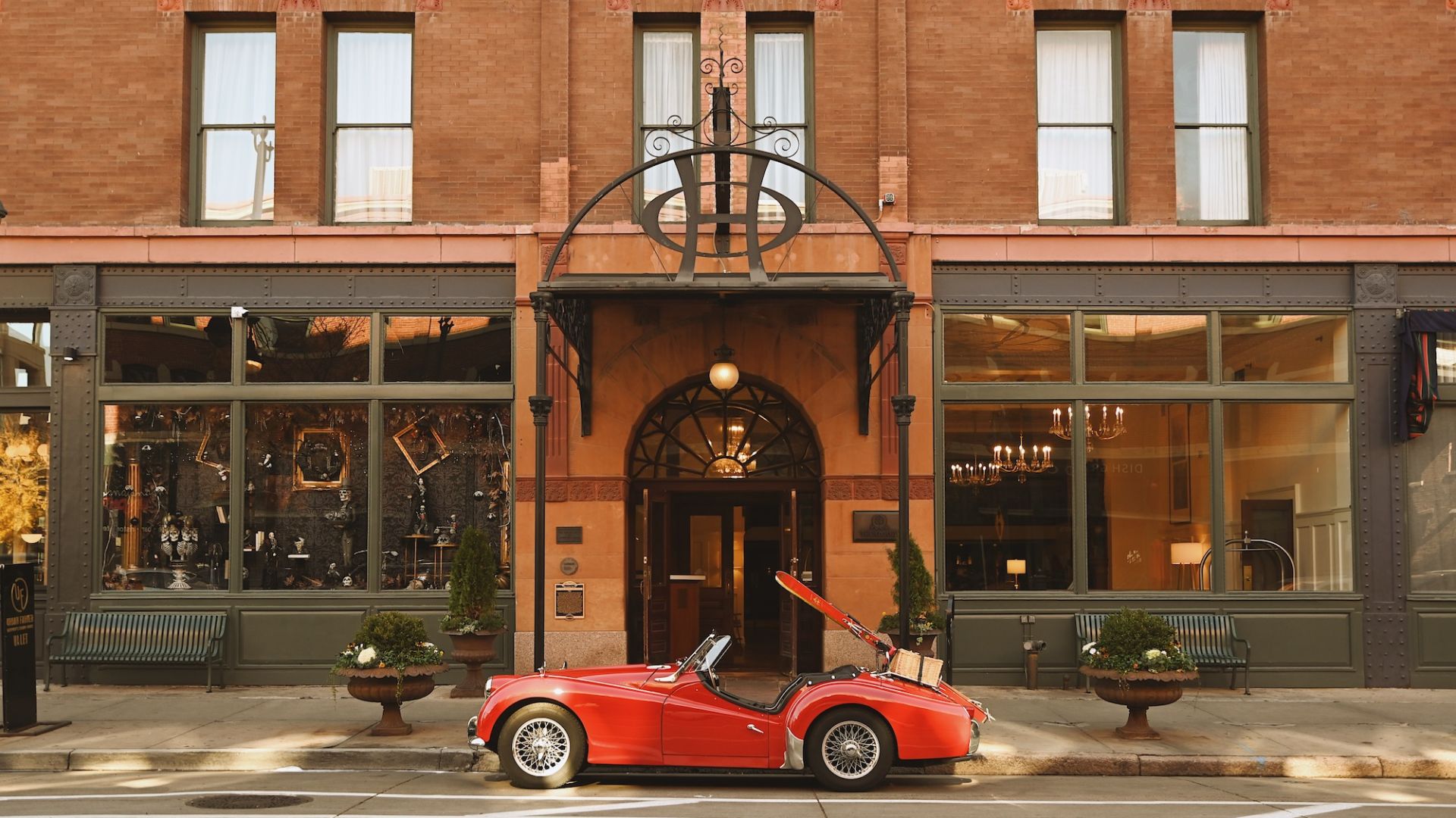 A Red Sports Car Parked In Front Of A Building